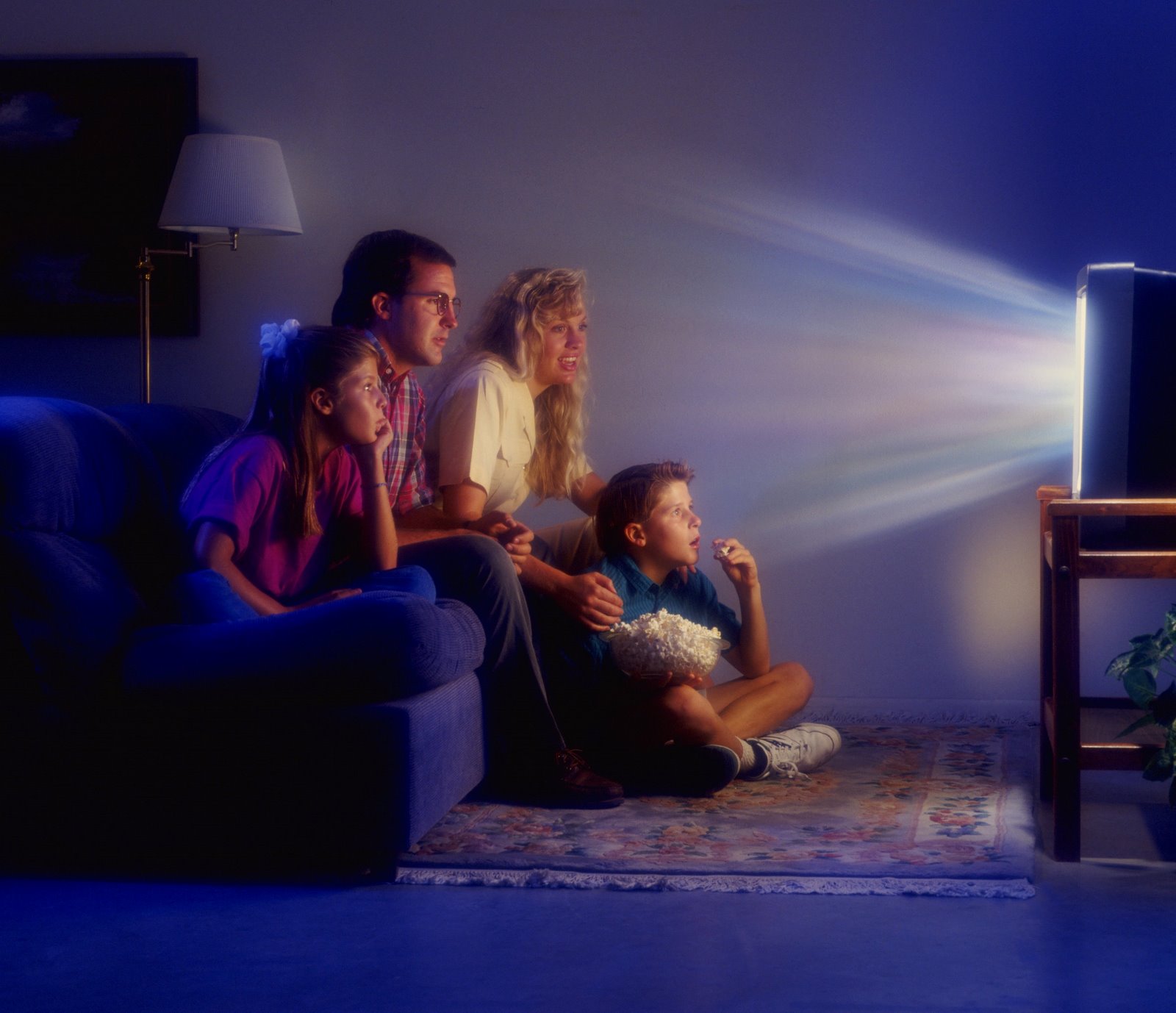 Watching their lives. Перед телевизором. Человек перед телевизором. Семья у телевизора. Человек смотрит телевизор.